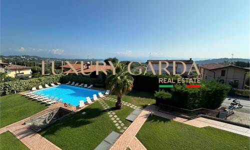 One-Bedroom Apartment with Double Garden and Pool.